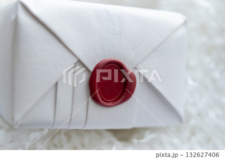 Wax seal stamp on white paper wrap packaging parcel box 132627406