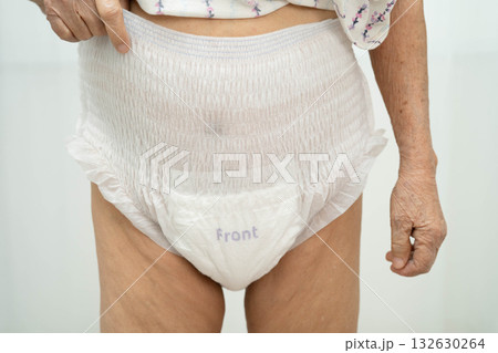 Asian senior woman patient wearing adult incontinence diaper pad in hospital. 132630264