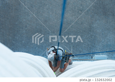 high-altitude climber. The profession of working at height. high-altitude climber. The profession of working at height. 132632002