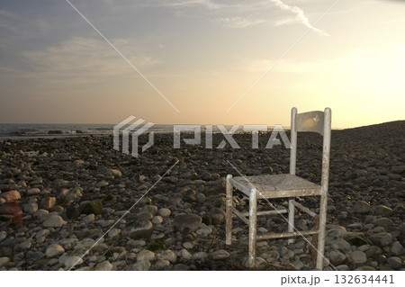 abandoned wooden chair on the seashore abandoned wooden chair on the seashore 132634441