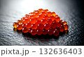 glistening salmon roe (ikura) gunkan-maki, the individual eggs bursting with color and moisture, on a textured, dark stone plate glistening salmon roe (ikura) gunkan-maki, the individual eggs bursting with color and moisture, on a textured, dark stone plate 132636403