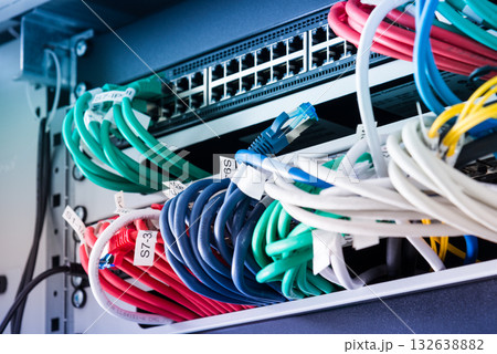 Fiber Optic cables connected to optic ports, network cables conn 132638882