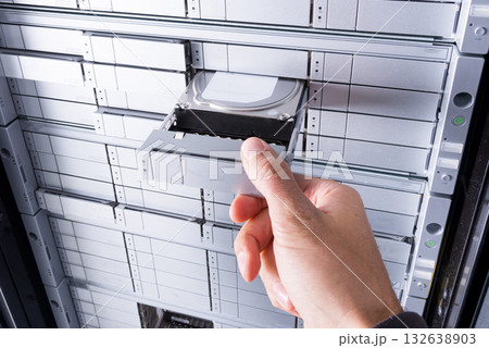 hand of IT technician installing hard drive with SAS interface i 132638903