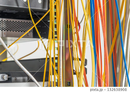 Detail of server room with bunch of fiber optic cables at the ba Detail of server room with bunch of fiber optic cables at the ba 132638908