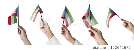 The Equatorial Guinea flag in hand in different angles on a white background The Equatorial Guinea flag in hand in different angles on a white background 132641673