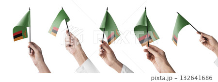 The Zambia flag in hand in different angles on a white background The Zambia flag in hand in different angles on a white background 132641686