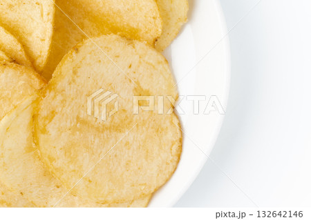 お皿に載せたポテトチップスのクローズアップ 132642146