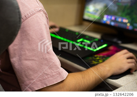 Gamer hands on modern backlit keyboard and mouse. Concept of gaming industry and computer gaming devices. Mechanical gaming keyboard on gamer desk at home 132642206