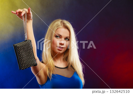 Elegant woman holds black handbag 132642510