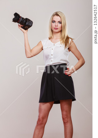 Beautiful woman with camera. 132642517