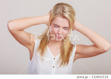 Closeup stressed business woman covers ears with hands 132642519