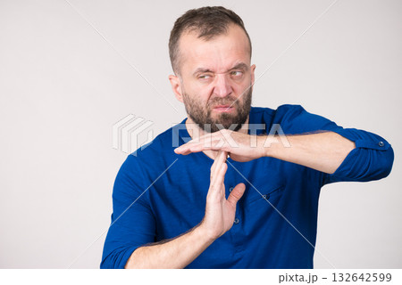Man showing time stop gesture Man showing time stop gesture 132642599