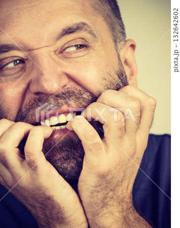 Man biting his nails Man biting his nails 132642602