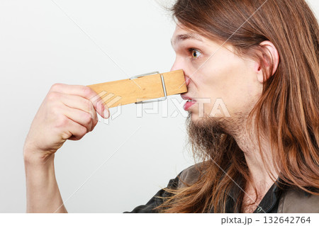 Man with clogged nose by clothespin 132642764
