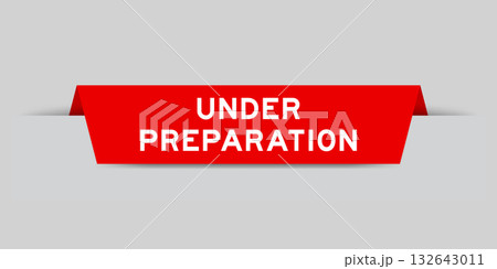 Red color inserted label with word under preparation on gray background Red color inserted label with word under preparation on gray background 132643011