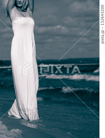 Young lady resting on beach. 132643200