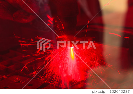 Laser cutting steel metal with bright sparks Laser cutting steel metal with bright sparks 132643287