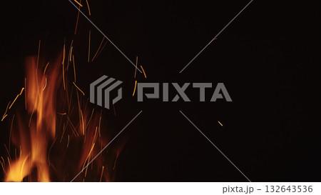 fire flames of campfire with sparks over black background, for overlay 132643536