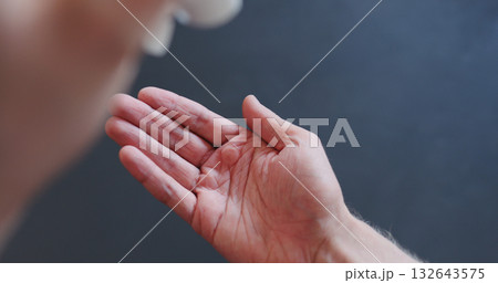 pov shot of man apply sanitizer gel to his hands closeup 132643575