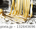 Fresh raw noodles made on home pasta machine closeup low angle view 132643696
