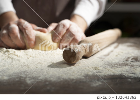 Baking concept. Caucasian female hands kneading the dough. Baking concept. Caucasian female hands kneading the dough. 132643862
