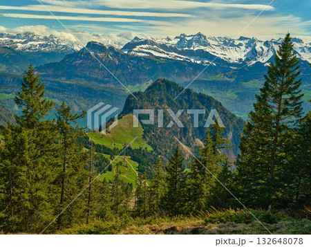 Majestic mountain landscape with lush greenery and snow-capped peaks in Switzerland during daytime Majestic mountain landscape with lush greenery and snow-capped peaks in Switzerland during daytime 132648078