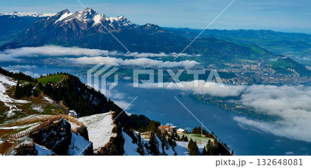 Breathtaking view of mountains and lake during clear weather in Switzerland with clouds lingering in the valley Breathtaking view of mountains and lake during clear weather in Switzerland with clouds lingering in the valley 132648081