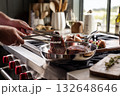 Man Cooking Steak in Stainless Steel Pan, Home Kitchen Interior 132648646