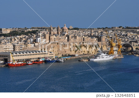 Grand harbour. Sightseeing cruise boat goes to the harbor. Aerial cityscape about the capitol of Malta Valetta city on the background 132648851