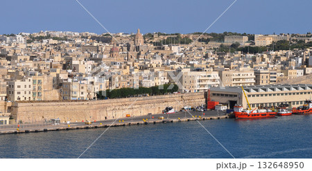 Grand harbour. Sightseeing cruise boat goes to the harbor. Aerial cityscape about the capitol of Malta Valetta city on the background 132648950