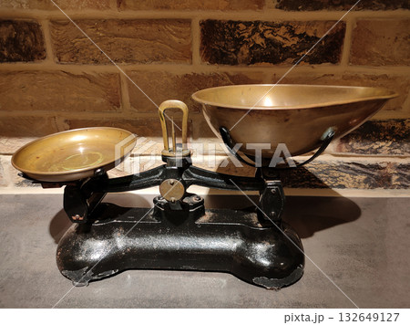 The ancient scales with the weight imbalance because a brass pendulum is on the left brass tray The ancient scales with the weight imbalance because a brass pendulum is on the left brass tray 132649127