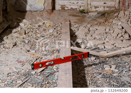A busy Construction Site featuring a Level Tool alongside various Debris scattered around 132649200