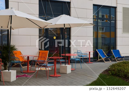 Vibrant Outdoor Caf Seating with Umbrellas 132649207