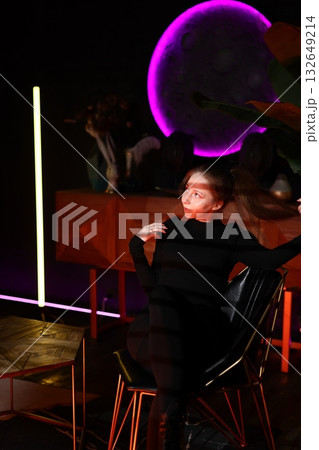 confident man in trendy sweater taking selfie amidst neon lighting and warm wood background 132649214