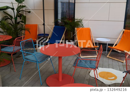A Colorful Outdoor Lounge Area that features Modern and Stylish Furniture for Relaxation 132649216