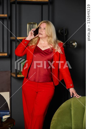 legal meeting scene, lawyer in red suit carefully reviews legal documents during tense negotiations legal meeting scene, lawyer in red suit carefully reviews legal documents during tense negotiations 132649219