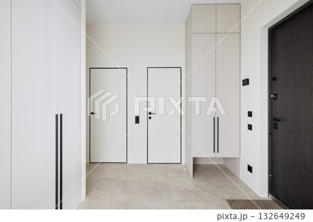A Modern Entrance Hallway featuring a Minimalist Design along with Neutral Tones and Colors A Modern Entrance Hallway featuring a Minimalist Design along with Neutral Tones and Colors 132649249