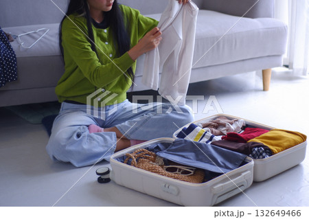 Young women packing luggage for holiday trip. 132649466