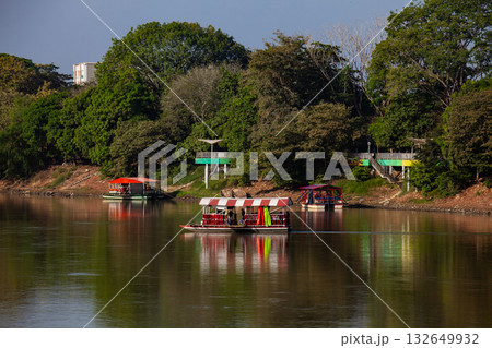 Non motorized ferry, called planchon, used by residents to cross the Sinu River from one bank to the other in the city of Monteria, Colombia. Non motorized ferry, called planchon, used by residents to cross the Sinu River from one bank to the other in the city of Monteria, Colombia. 132649932