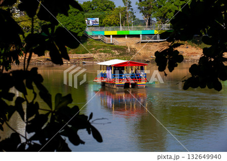 Non motorized ferry, called planchon, used by residents to cross the Sinu River from one bank to the other in the city of Monteria, Colombia. Non motorized ferry, called planchon, used by residents to cross the Sinu River from one bank to the other in the city of Monteria, Colombia. 132649940