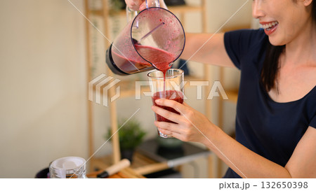 Photo set of a woman making a fruit smoothie in her home kitchen, reflecting a healthy and balanced daily lifestyle Photo set of a woman making a fruit smoothie in her home kitchen, reflecting a healthy and balanced daily lifestyle 132650398