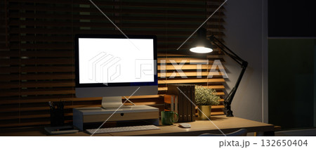 Workspace peaceful night time computer empty screen with office supply 132650404