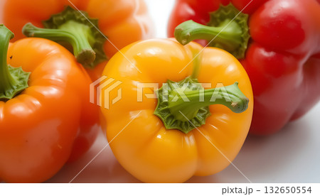 Close up of vibrant orange and red bell peppers vegetables food Close up of vibrant orange and red bell peppers vegetables food 132650554
