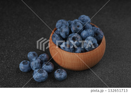 Fresh ripe blueberries in wooden bowl on dark gray stone background closeup macro healthy food 132651713