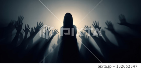 Silhouette of Woman Surrounded by Accusing Hands in Dramatic Backlighting 132652347