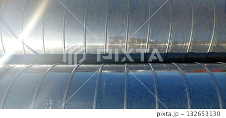 Stainless Steel Ventilation Pipes Reflecting Sunlight During Installation at a Construction Site Stainless Steel Ventilation Pipes Reflecting Sunlight During Installation at a Construction Site 132653130