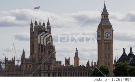 United Kingdom flag waving over Palace of Westminster with Big Ben in London United Kingdom flag waving over Palace of Westminster with Big Ben in London 132654994
