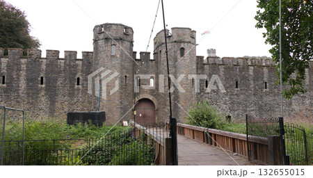Wooden bridge leading to the gatehouse of Cardiff Castle flying the Welsh flag Wooden bridge leading to the gatehouse of Cardiff Castle flying the Welsh flag 132655015