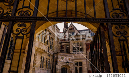 Wrought iron gate revealing the courtyard of a historic building in Cambridge Wrought iron gate revealing the courtyard of a historic building in Cambridge 132655021