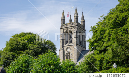 All Saints  Church rising over green trees in Helmsley, North York Moors National Park 132655072